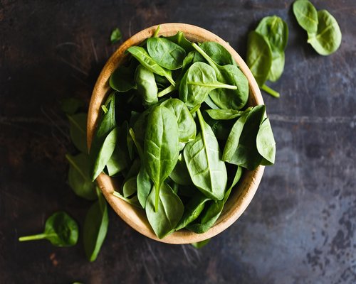 Vibrant green spinach leaves freshly washed in a kitchen bowl